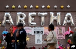 People gather outside New Bethel Baptist Church before a viewing for Aretha Franklin, Aug. 30, 2018, in Detroit.