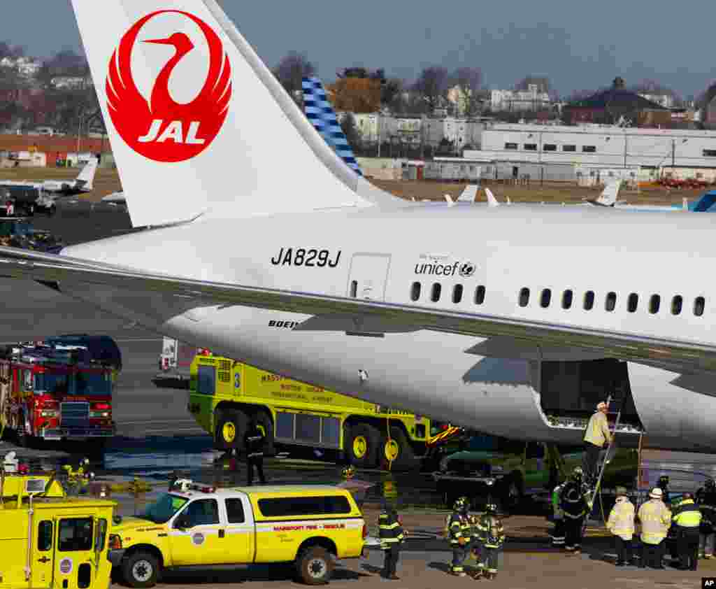 A Japan Airlines Boeing 787 Dreamliner jet surrounded by emergency vehicles at Logan International Airport in Boston, January 7, 2013. A small electrical fire filled the cabin of the JAL aircraft with smoke. 