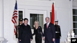 Vice President Joe Biden and Jill Biden welcome Chinese Vice President Xi Jinping to a dinner at the Naval Observatory in Washington, Tuesday, Feb. 14, 2012.