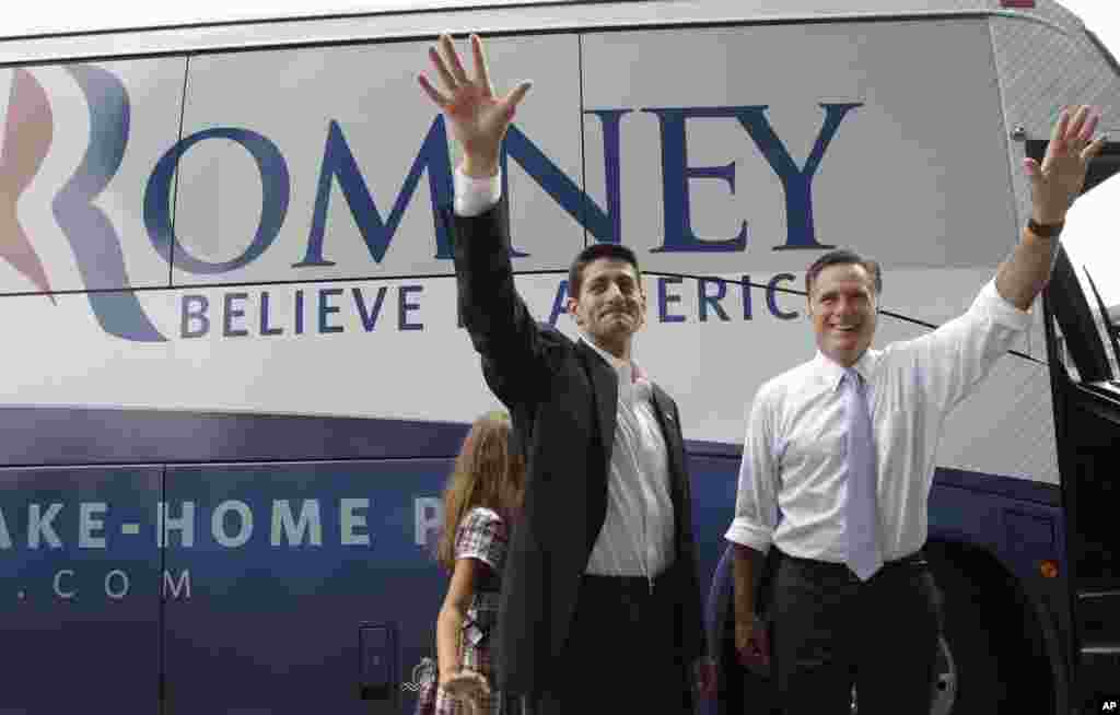 Republican presidential candidate Mitt Romney, right, and vice presidential candidate Wisconsin Rep. Paul Ryan are joined by Ryan&#39;s daughter Liza as they wave to the crowd, Aug. 11, 2012, in Norfolk, Va. 