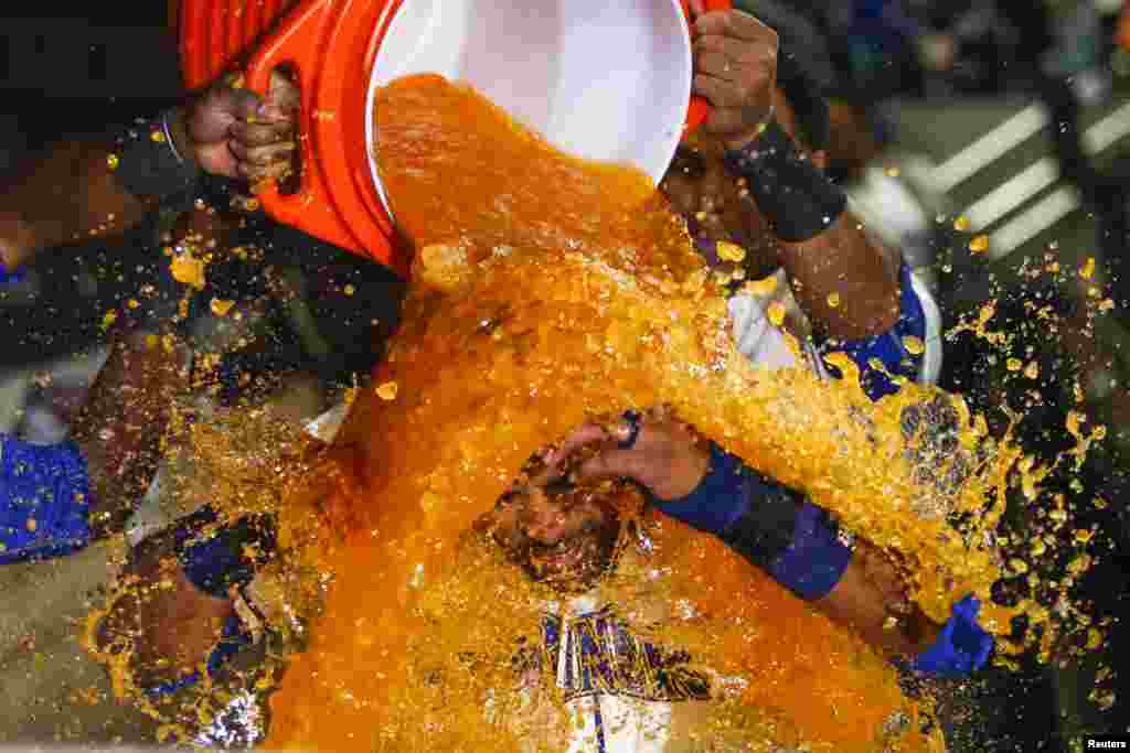 Seattle Mariners left fielder Franklin Gutierez (30) is doused with sports drink in the dugout after hitting a walk-off solo-homer against the Toronto Blue Jays during the tenth inning at Safeco Field in Seattle, Washington, July 26, 2015. Seattle defeated Toronto, 6-5. (Credit: Joe Nicholson/USA TODAY Sports)