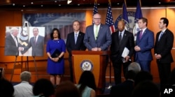 Rep. Joe Crowley, D-N.Y., center, joined by, from left, Rep. Pramila Jayapal, D-Wash., Rep. Adam Schiff, D-Calif., ranking member of the House Intelligence Committee, Rep. Elijah Cummings, D-Md., Rep. Eric Swalwell, D-Calif., and Rep. Ruben Kihuen, D-Nevada, speaks next to a photo of U.S. President Donald Trump and Russian Foreign Minister Sergey Lavrov during a news conference on Capitol Hill in Washington, May 17, 2017.