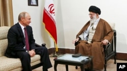 FILE - In this picture released by the office of Iran's supreme leader, Ayatollah Ali Khamenei, right, speaks with Russian President Vladimir Putin during their meeting in Tehran, Iran, Nov. 1, 2017.