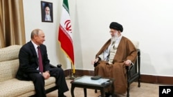 In this picture released by the office of Iran's supreme leader, Supreme Leader Ayatollah Ali Khamenei, right, speaks with Russian President Vladimir Putin during their meeting in Tehran, Iran, Nov. 1, 2017.