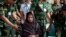 Reshma Begum, center, the 19-year-old seamstress who spent 17 days trapped in the rubble of a collapsed factory building talks to the media at a hospital in Savar, near Dhaka, Bangladesh, May 13, 2013. 