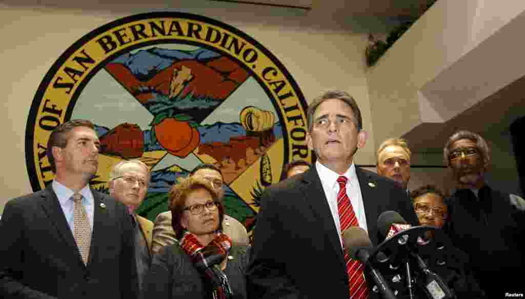 Mayor Carey Davis (C) talks to the media, after an emergency city council meeting about the shooting rampage at the Inland Regional Center.