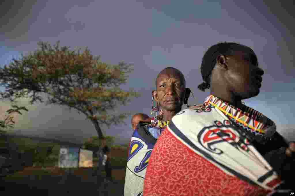 Masaai women line up at dawn to vote in a general election in Kumpa, Kenya. Kenyans went to the polls to begin casting votes in a nationwide election seen as the country&#39;s most important - and complicated - in its 50-year history.