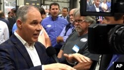 FILE - EPA Administrator Scott Pruitt talks to a reporter after speaking at Whayne Supply in Hazard, Ky., Oct. 9, 2017. Pruitt said Jan.31, 2018, that federal rule changes aimed at protecting drinking water sources were confusing, especially for farmers and ranchers, so the matter has been put on hold for two years.