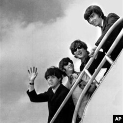 The Beatles, (from left) Paul McCartney, Ringo Starr, John Lennon and George Harrison board a plane for England at a New York airport in 1964.