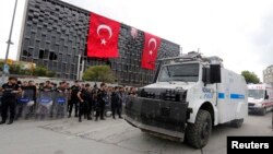 Turkish riot police take up position in Taksim Square in Istanbul June 12, 2013.