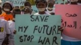 FILE - Women from more than forty South Sudanese womens organizations carry placards as march through Juba to express the frustration and suffering that women and children have endured during years of conflict, in Juba, South Sudan, Dec. 9, 2017. 