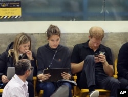 Prince Harry checks his smartphone during the Wheelchair Rugby competition at 2017 Invictus Games in Toronto on September 28, 2017.