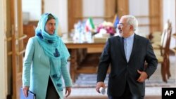 Iranian Foreign Minister Mohammad Javad Zarif and European Union foreign policy chief Federica Mogherini arrive to attend a press briefing after their meeting in Tehran, Iran, April 16, 2016.