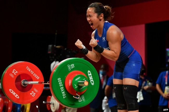 FILE - Philippines' Hidilyn Diaz reacts while competing in the women's 55kg weightlifting competition during the Tokyo 2020 Olympic Games at the Tokyo International Forum in Tokyo on July 26, 2021. (Photo by Vincenzo PINTO / AFP)