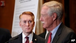 Sen. James Lankford, R-Okla., listens as Sen. Angus King, I-Maine, speaks about immigration and the Deferred Action for Childhood Arrivals (DACA) program, Feb. 7, 2018, on Capitol Hill in Washington. 
