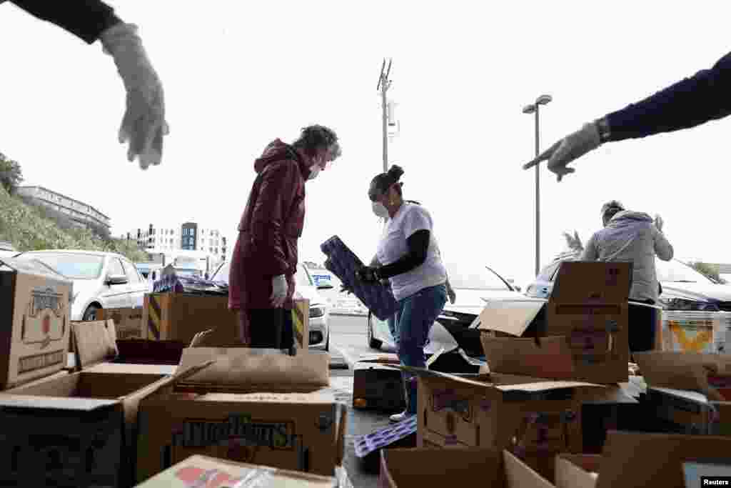 Volunteers sort apples at the San Francisco-Marin Food Bank, amid the novel coronavirus outbreak, in San Francisco, California, March 16, 2020.