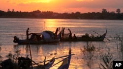 Cambodian catches fish in the Mekong River during the rainy season, near Phnom Penh, Cambodia, Aug. 17, 2014. More than 30 people have been killed by floods during the country's rainy season this year and more than 10,000 families have been evacuated from their homes to escape rising floodwaters. (AP Photo/Heng Sinith)