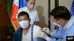 FILE - This handout photo taken May 3, 2021, and received from the Presidential Photo Division May 4, 2021, shows Philippine President Rodrigo Duterte receiving a dose of China's Sinopharm COVID vaccine at Malacanang Palace in Manila.