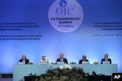 Turkish Foreign Minister Mevlut Cavusoglu, center, Organization of Islamic Cooperation (OIC) Secretary General, Yousef bin Ahmed Al-Othaimeen, second left, Bangladeshi Foreign Minister Hassan Mahmood Ali, second right, and other ministers attend the Extraordinary summit of the OIC in Istanbul, Turkey, May 18, 2018.