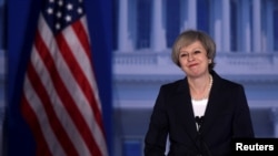 Britain's Prime Minister Theresa May acknowledges applause before speaking during the 2017 "Congress of Tomorrow" Joint Republican Issues Conference in Philadelphia, Pennsylvania, Jan. 26, 2017.