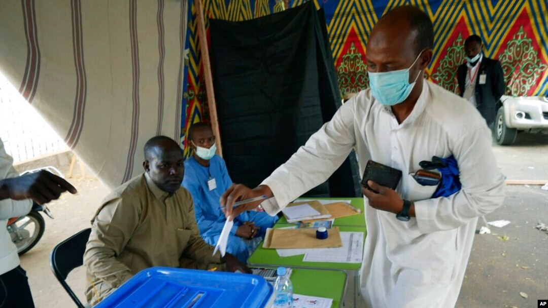 FILE - A man votes at a polling station in N'djamena, Chad, April 11, 2021. Chadian President Idriss Debi is seeking to extend his three-decade-long rule, running for a sixth time in this oil-producing Central African nation.