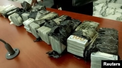 U.S. dollar currency, recovered from three Chinese citizens arrested in possession of gold bars and $400,000, is displayed inside the courtroom in Bukavu, Congo, Jan. 4, 2025. The men were sentenced to seven years in prison on Jan. 14, 2025.