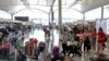 Travelers wait to check in for their flights at the airport in Hong Kong, Aug. 14, 2019. Flights resumed at Hong Kong's airport Wednesday morning. 