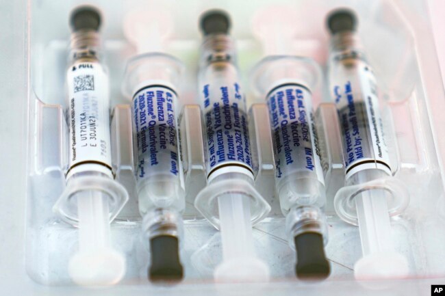 A file photo showing flu vaccine syringes in 2020. Experts are expecting a bad flu season in the U.S. this winter. (AP Photo/Damian Dovarganes)