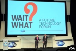 DARPA director Arati Prabhakar, left, and Defense Secretary Ash Carter welcome visitors at the opening of a conference aimed at highlighting innovative technologies and fostering an interdisciplinary approach to problem-solving. (Credit: Art Chimes/VOA)