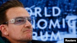 FILE - Singer Bono attends a session at the annual meeting of the World Economic Forum (WEF) in Davos, Switzerland, Jan. 24, 2014. 
