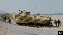 FILE - U.S. and Philippine troops disembark from an assault vehicle during a joint exercise at the Naval Education and Training Command at San Antonio township, Zambales province, northwest of Manila, Philippines, April 21, 2015.