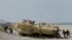FILE - U.S. and Philippine troops disembark from an assault vehicle during a joint exercise at the Naval Education and Training Command at San Antonio township, Zambales province, northwest of Manila, Philippines, April 21, 2015.