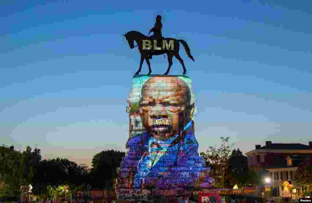 The image of late Rep. John Lewis, a pioneer of the civil rights movement and long-time member of the U.S. House of Representatives, is projected on the statue of Confederate General Robert E. Lee in Richmond, Virginia, July 19, 2020.