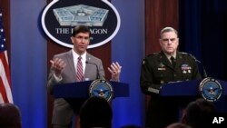 Defense Secretary Mark Esper, left, speaks as Chairman of the Joint Chiefs of Staff Army Gen. Mark Milley, right, listens during a briefing at the Pentagon in Washington, Monday, March 2, 2020. (AP Photo/Susan Walsh)