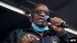 (FILES) In this file photo taken on July 04, 2021 Former South African president Jacob Zuma addresses his supporters in front of his rural home in Nkandla for the first time since he was given a 15-months sentence for contempt of court. - South…