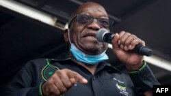 (FILES) In this file photo taken on July 04, 2021 Former South African president Jacob Zuma addresses his supporters in front of his rural home in Nkandla for the first time since he was given a 15-months sentence for contempt of court. - South…