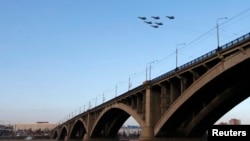 FILE - Jet fighters from the Su-30 SM "Sokoly Rossii" (Falcons of Russia) aerobatic team fly during rehearsals for a show above the Yenisei River in Krasnoyarsk, Siberia, Oct. 2014.