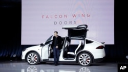 FILE - Elon Musk, CEO of Tesla Motors Inc., introduces the Model X car at the company's headquarters in Fremont, Calif., Sept. 29, 2015.