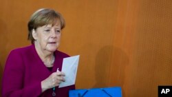 German Chancellor Angela Merkel arrives at the weekly cabinet meeting of the German government at the chancellery in Berlin, Wednesday, April 18, 2018. 