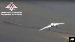 In this video grab made available on Wednesday, Aug. 7, 2019 by Russian Defense Ministry Press Service, Russia's military drone Okhotnik is seen in flight at an unidentified location in Russia. The ministry said the drone, which has stealth…