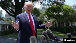 U.S. President Donald Trump talks to reporters as he departs for travel to the G-20 Summit in Osaka, Japan, at the White House in Washington, June 26, 2019. 