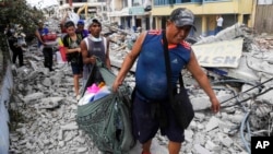 Residents recover their belongings days after an earthquake in Pedernales, Ecuador, April 20, 2016.