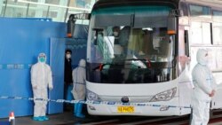 世卫新冠病毒源头调查组在武汉天河国际机场乘坐大巴车。（2021年1月14日）