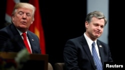 FILE - U.S. President Donald Trump and FBI Director Christopher Wray participate in a graduation ceremony at the FBI Academy on the grounds of Marine Corps Base Quantico in Quantico, Virginia, U.S. Dec. 15, 2017.