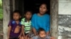 Claudia Maquin, mother of Jakelin Caal Maquin, a 7-year-old girl who died in U.S. custody, stands with her other children outside her house in Raxruha, Guatemala, Dec. 15, 2018.