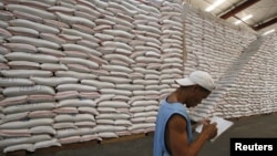 A National Food Authority (NFA) worker makes an inventory of rice stocks at a government rice warehouse in Taguig, Metro Manila, March 11, 2014.
