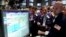 Specialist Jay Woods, right, works with traders on the floor of the New York Stock Exchange, June 28, 2012. 