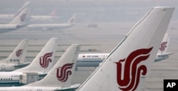 FILE - Air China planes wait on the tarmac of the Beijing Capital International Airport.