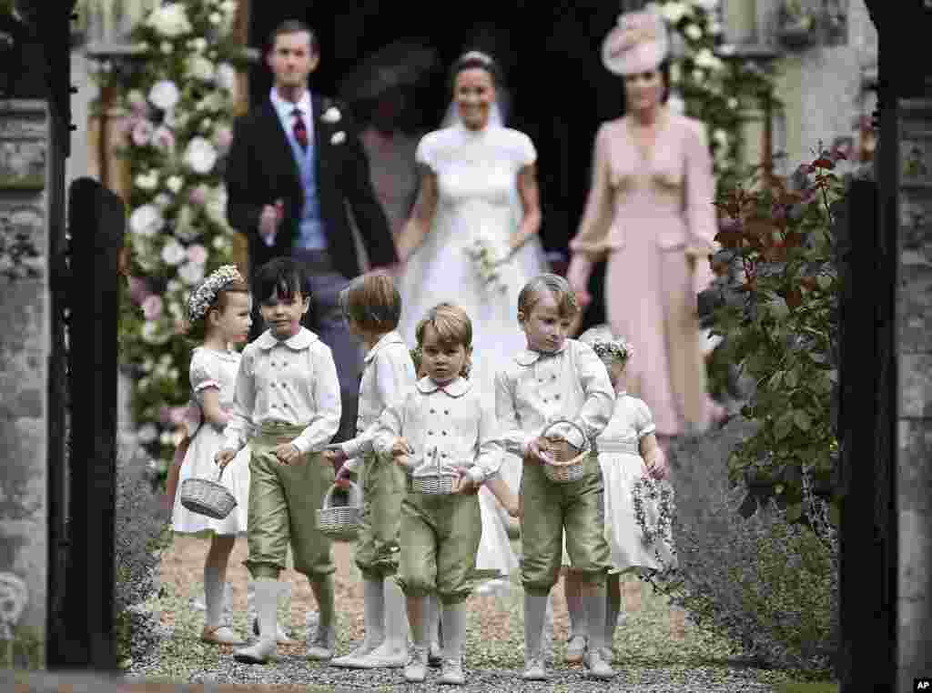 Britain's Prince George, foreground center, reacts after the wedding of his aunt, Pippa Middleton to Hedge Fund manager James Matthews, at St Mark's Church in Englefield, England, May 20, 2017.