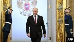 In this pool photograph distributed by Russian state agency Sputnik, Russian president-elect Vladimir Putin walks prior to his inauguration ceremony at the Kremlin in Moscow on May 7, 2024.